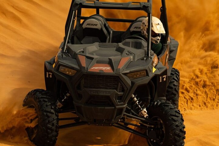Experience the vast Arabian desert as you navigate stunning dunes in a Polaris buggy guided by professionals who ensure a safe and exciting adventure in Dubai's remarkable landscape.